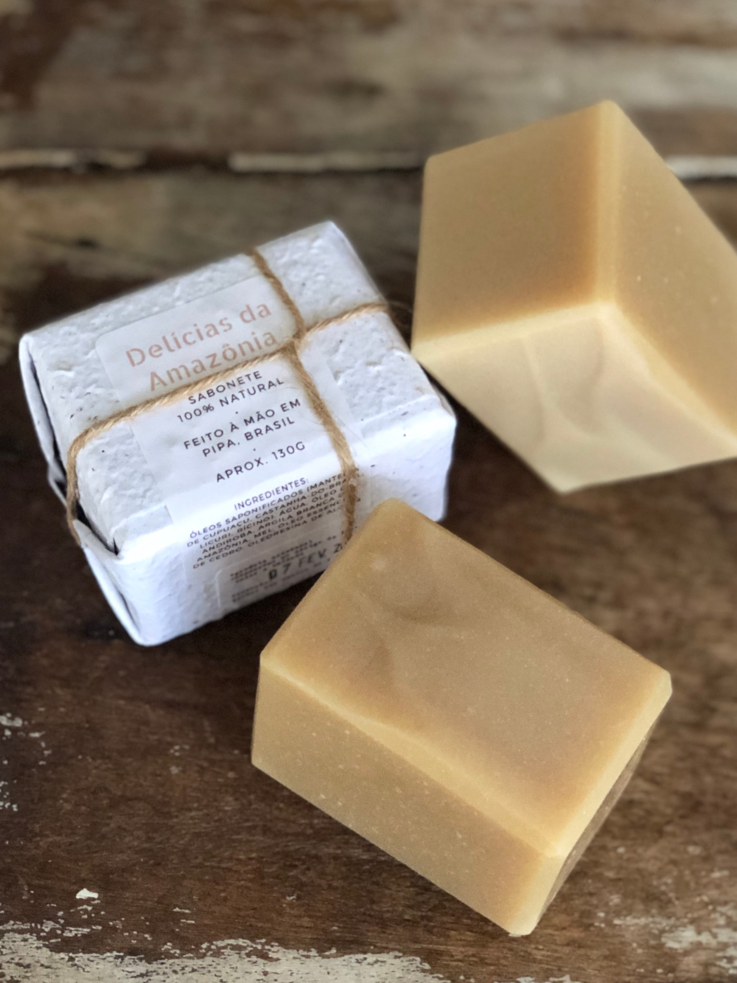 Sabonetes 100% naturais, um deles embalado em papel com etiqueta e barbante de juta